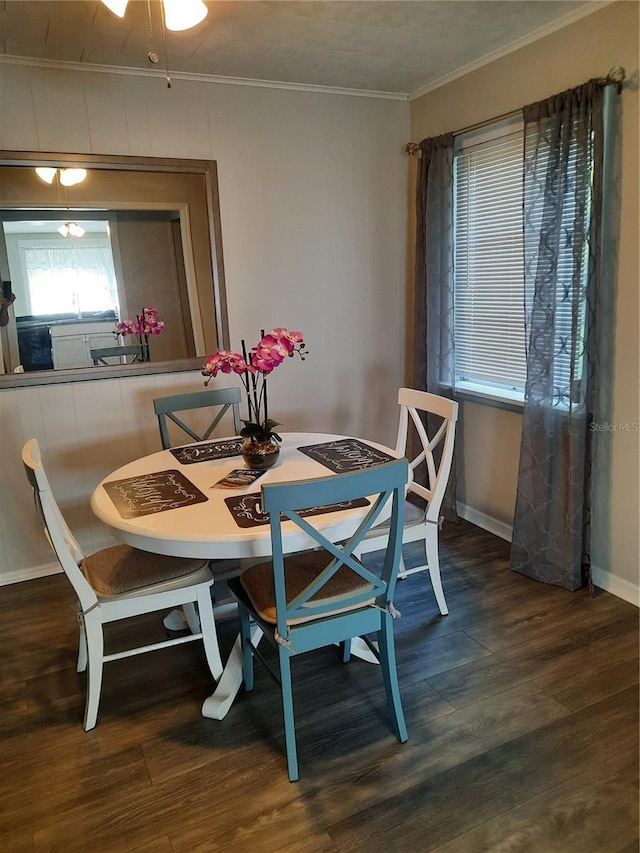 dining area featuring dark hardwood / wood-style flooring and ornamental molding