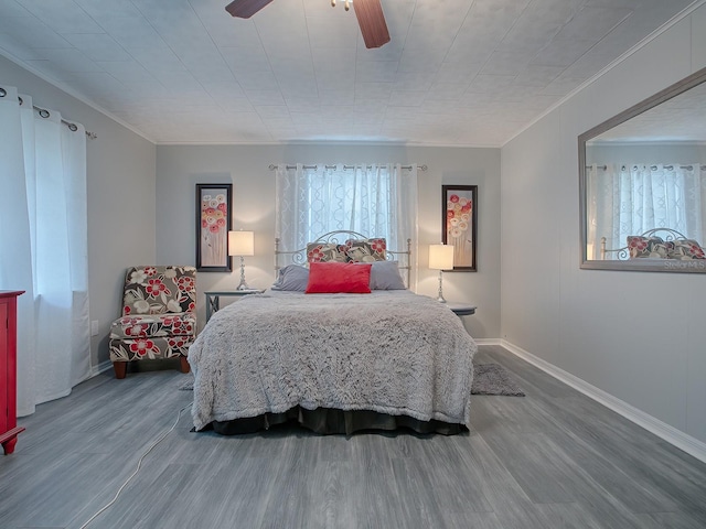 bedroom featuring crown molding, hardwood / wood-style floors, and ceiling fan