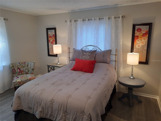 bedroom featuring wood-type flooring and ornamental molding