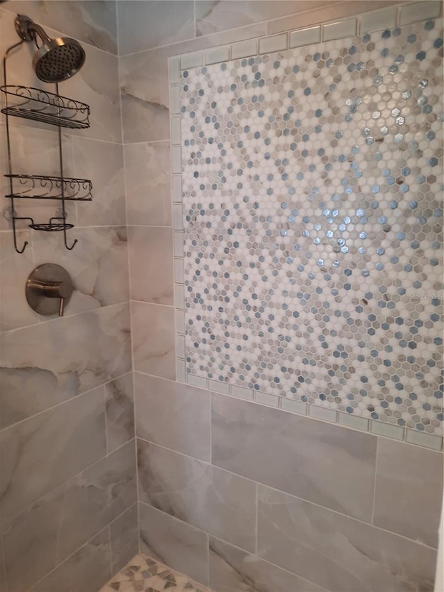 bathroom with tiled shower
