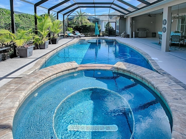 view of pool with a patio, an in ground hot tub, a lanai, grilling area, and ceiling fan