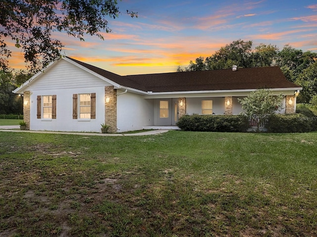 single story home featuring a yard