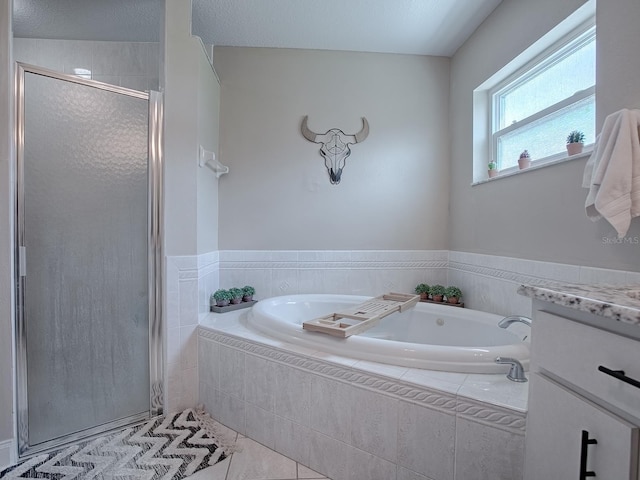 bathroom featuring tile patterned flooring, vanity, and plus walk in shower