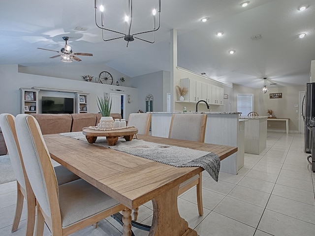 dining space featuring ceiling fan, lofted ceiling, and light tile patterned floors