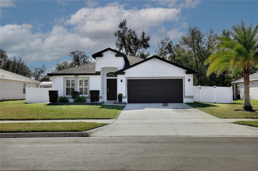 view of front of house featuring a garage and a front yard