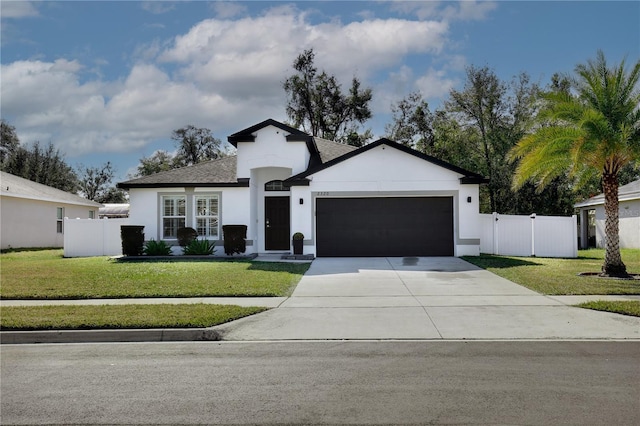 view of front of house with a garage and a front lawn