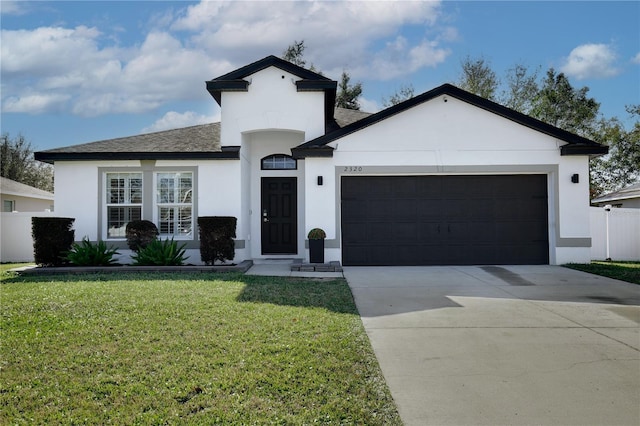 view of front of home with a garage and a front yard