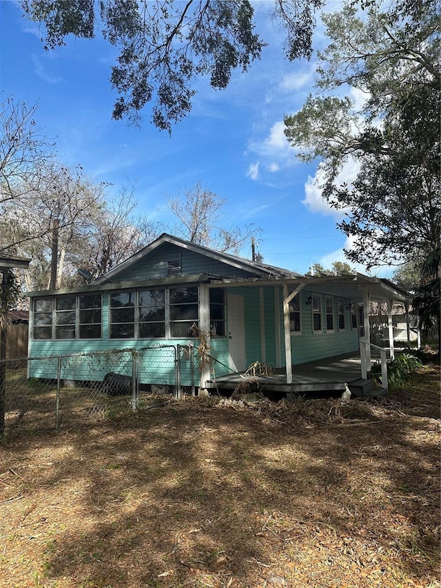 view of front of house with a sunroom