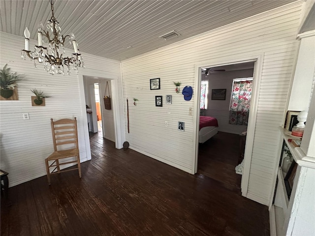 hall featuring a notable chandelier and dark hardwood / wood-style flooring