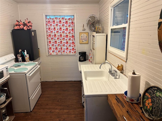 kitchen with sink, dark wood-type flooring, white electric stove, and black fridge