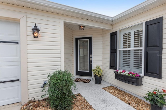 doorway to property with an attached garage