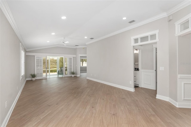 unfurnished living room with lofted ceiling, visible vents, baseboards, ornamental molding, and light wood-type flooring