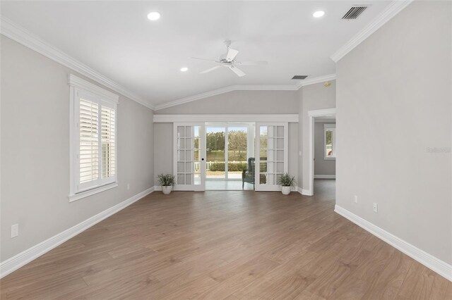 unfurnished room featuring visible vents, baseboards, french doors, ornamental molding, and light wood-type flooring