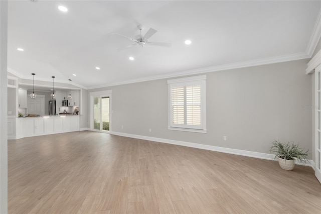 unfurnished living room with ornamental molding, light wood-type flooring, baseboards, and a ceiling fan