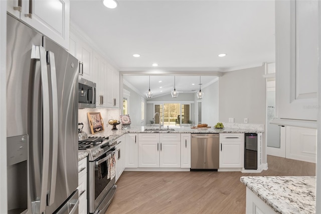 kitchen featuring white cabinetry, appliances with stainless steel finishes, and a sink