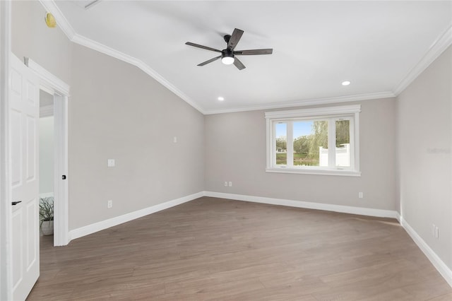 spare room with crown molding, recessed lighting, ceiling fan, wood finished floors, and baseboards