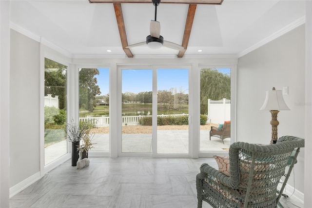 sunroom / solarium featuring beamed ceiling, a water view, and a ceiling fan