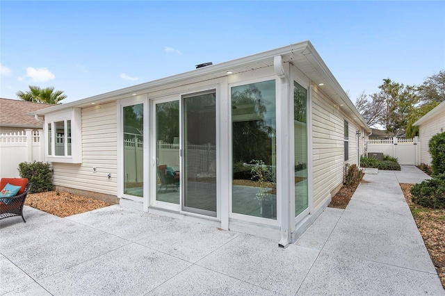 back of property with a patio area and fence