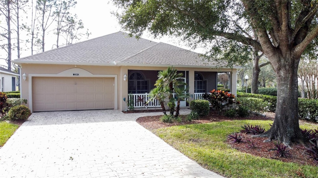 single story home with a garage and covered porch