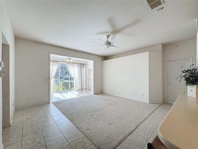 spare room featuring ceiling fan and a textured ceiling