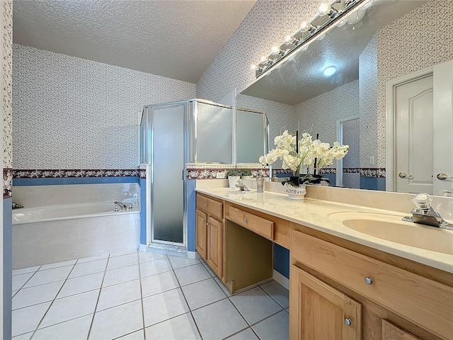 bathroom featuring tile patterned floors, plus walk in shower, a textured ceiling, and vanity