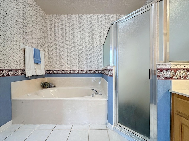 bathroom featuring tile patterned flooring, plus walk in shower, and vanity