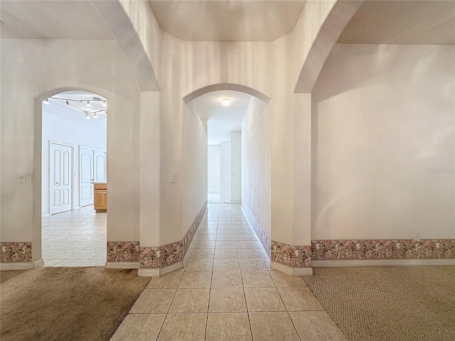 hall featuring light tile patterned flooring