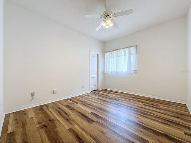 spare room with ceiling fan, hardwood / wood-style floors, and a textured ceiling