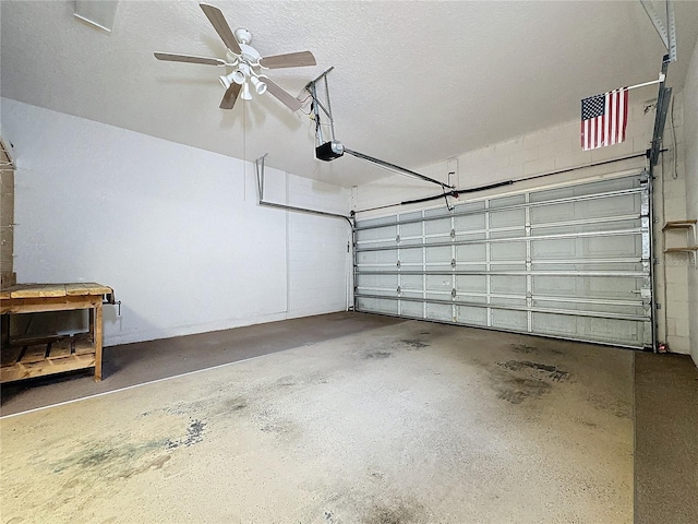 garage with ceiling fan and a garage door opener