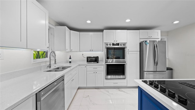 kitchen with white cabinetry, sink, and stainless steel appliances