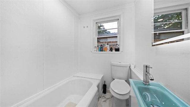 bathroom featuring toilet, a bathing tub, and sink