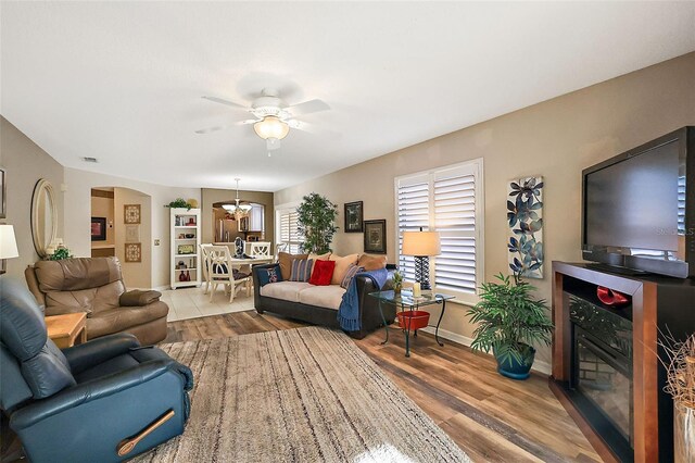 living room featuring light hardwood / wood-style floors and ceiling fan