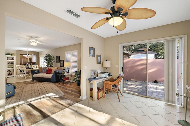 interior space featuring ceiling fan and a wealth of natural light