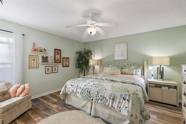 bedroom with hardwood / wood-style flooring, ceiling fan, and a textured ceiling