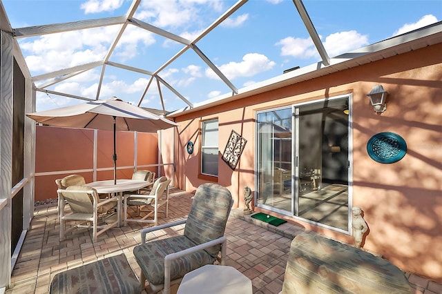 view of patio / terrace featuring glass enclosure
