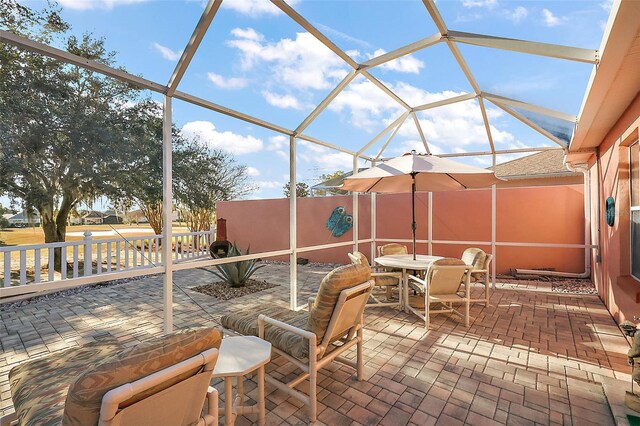 view of patio / terrace featuring a lanai