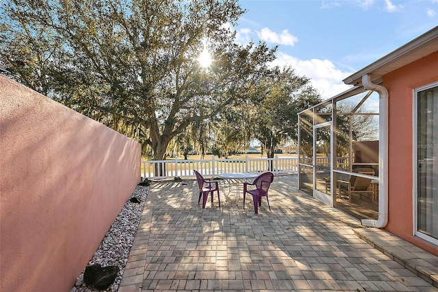 view of patio / terrace featuring a lanai