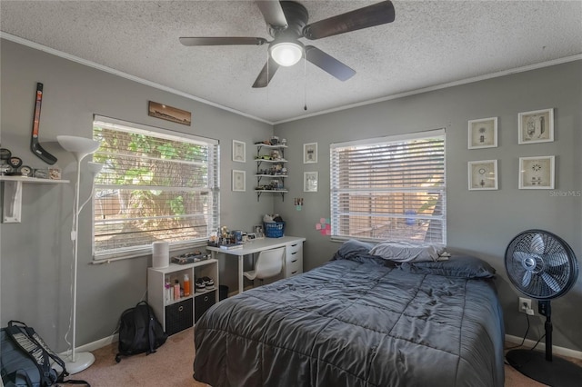 carpeted bedroom with ornamental molding, ceiling fan, and a textured ceiling