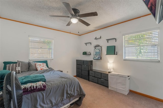 carpeted bedroom with crown molding, ceiling fan, and a textured ceiling