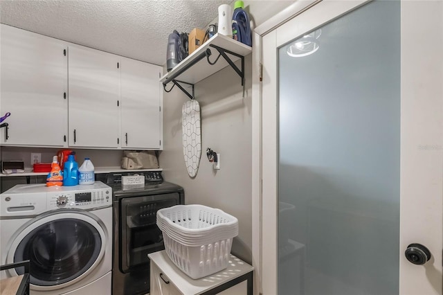 laundry room featuring cabinets, independent washer and dryer, and a textured ceiling