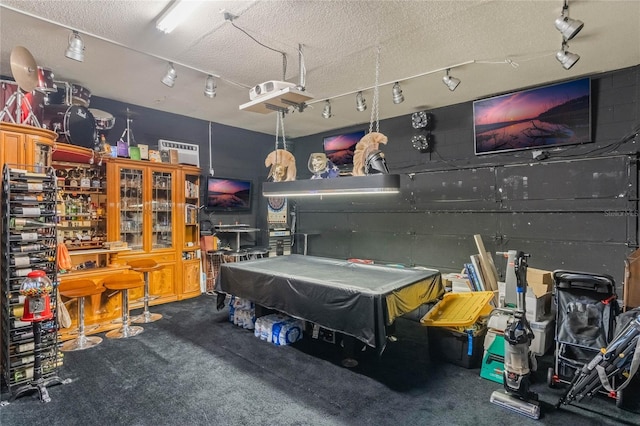 rec room with track lighting, a textured ceiling, and billiards