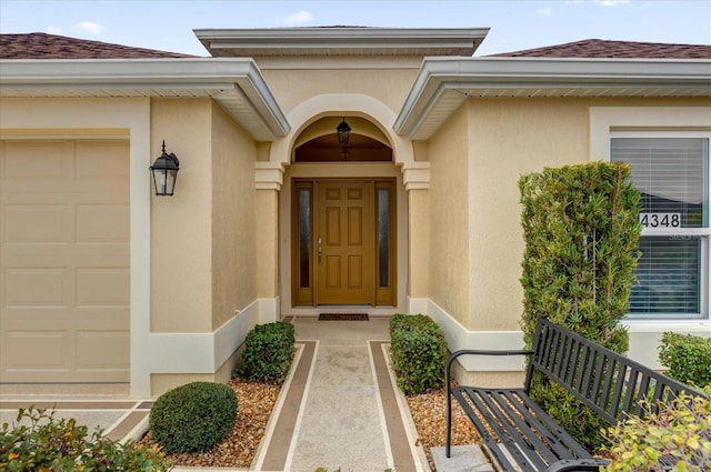 view of exterior entry with a garage