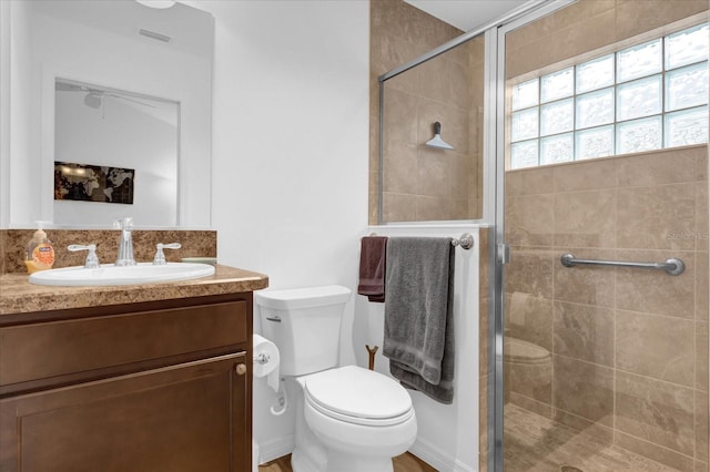 bathroom featuring vanity, toilet, and walk in shower