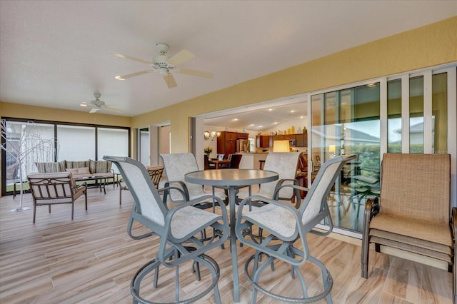 sunroom / solarium featuring ceiling fan