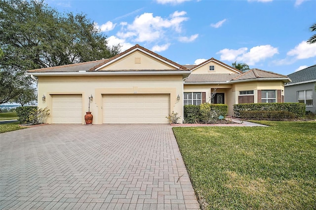 view of front of property with a garage and a front lawn