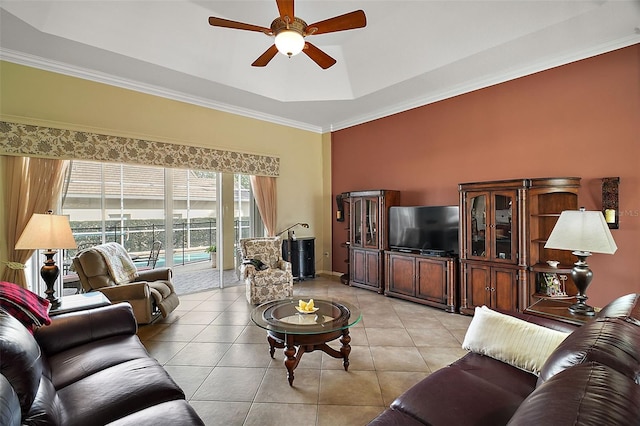 tiled living room featuring a raised ceiling, crown molding, and ceiling fan