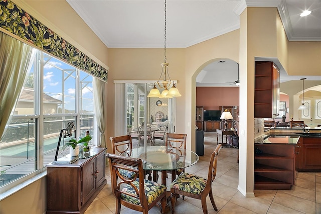 tiled dining room featuring crown molding and ceiling fan