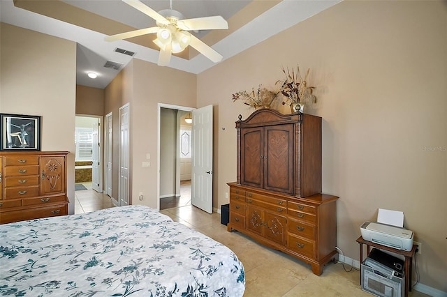 tiled bedroom featuring ceiling fan, ensuite bath, and a closet