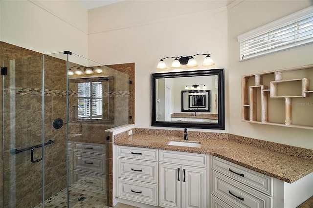 bathroom featuring vanity, a healthy amount of sunlight, and walk in shower