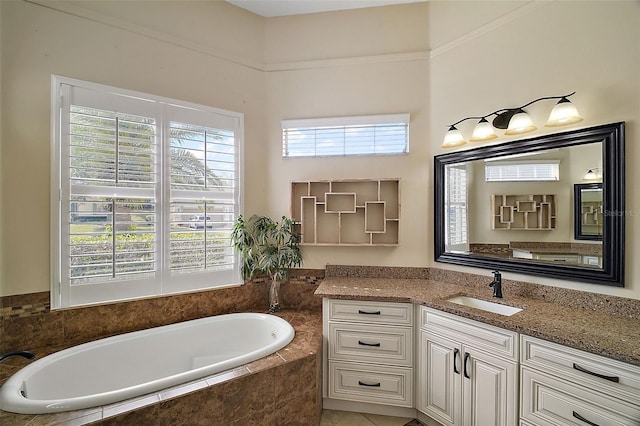 bathroom with vanity and tiled tub